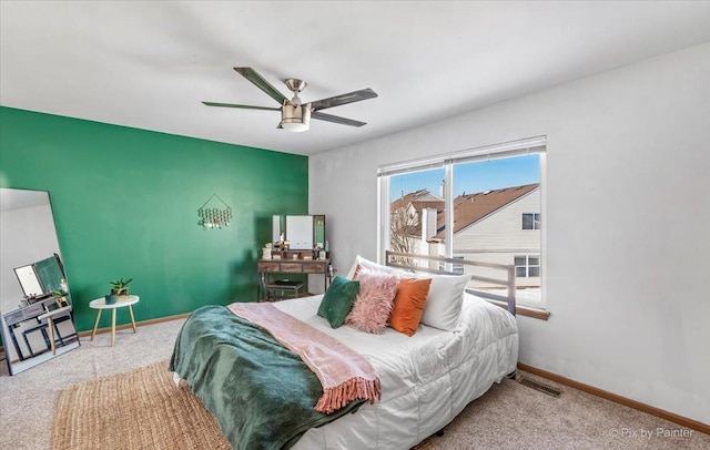 carpeted bedroom with a ceiling fan, baseboards, and visible vents