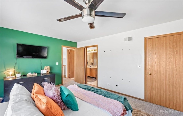 bedroom featuring visible vents, connected bathroom, carpet floors, and ceiling fan