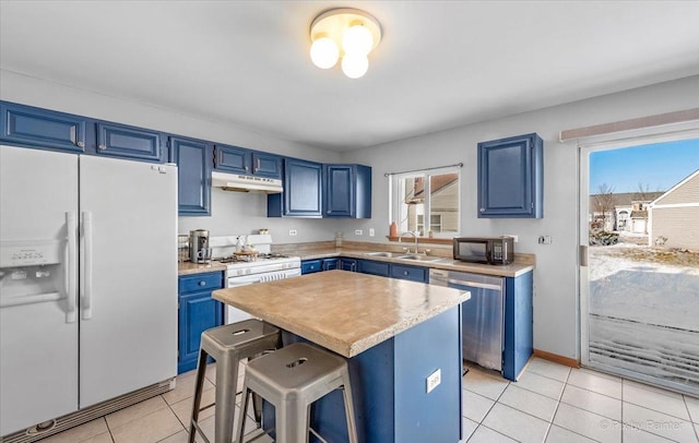 kitchen featuring black microwave, white fridge with ice dispenser, under cabinet range hood, stainless steel dishwasher, and blue cabinets