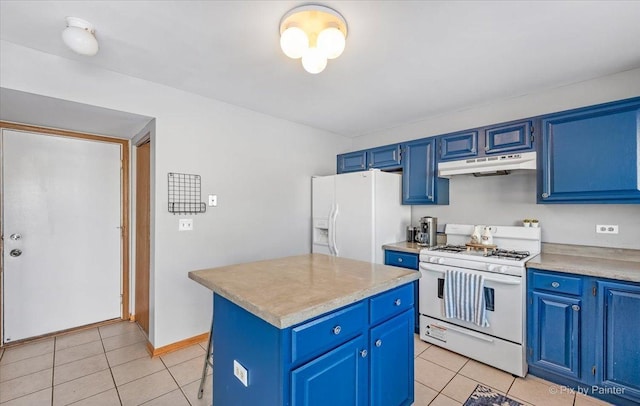 kitchen with light tile patterned floors, blue cabinets, under cabinet range hood, and white appliances