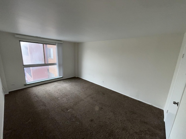 300 Park Ave Unit 443, Calumet City, IL 60409 - spare room with dark carpet and baseboards