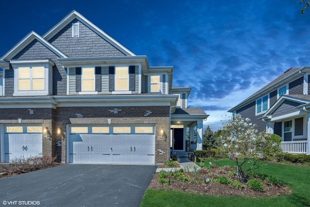 3S622 Breme Dr, Warrenville, IL 60555 - view of front facade with an attached garage, driveway, and brick siding