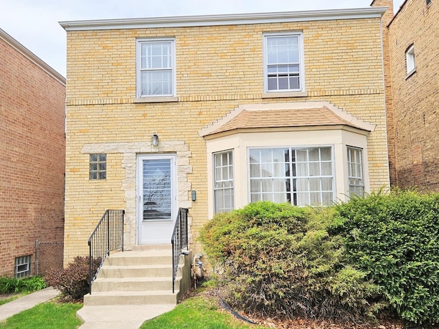 townhome / multi-family property featuring brick siding