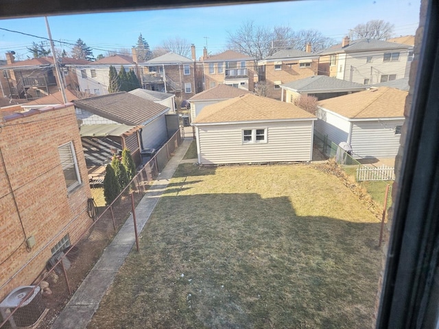 view of yard with a fenced backyard and a residential view