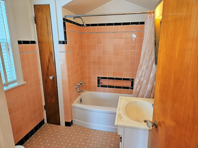 full bath with vanity, tile walls, tile patterned flooring, and shower / tub combo with curtain