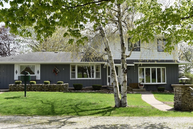 view of front of house featuring board and batten siding and a front yard