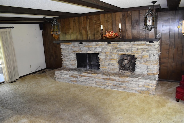 unfurnished living room with wooden walls, beamed ceiling, and carpet