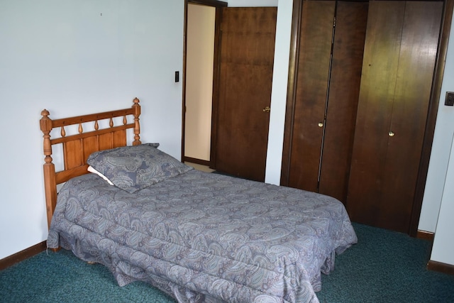 carpeted bedroom with baseboards and two closets