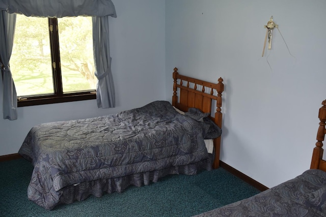 carpeted bedroom featuring baseboards