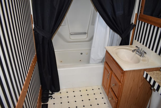 bathroom with vanity, shower / bathtub combination with curtain, tile patterned floors, and wallpapered walls