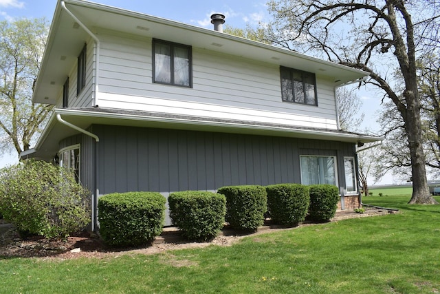 view of property exterior with a lawn