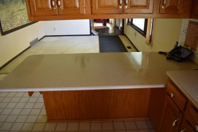 17864 E 1700 N Rd, Pontiac, IL 61764 - kitchen featuring light countertops, brown cabinets, and visible vents