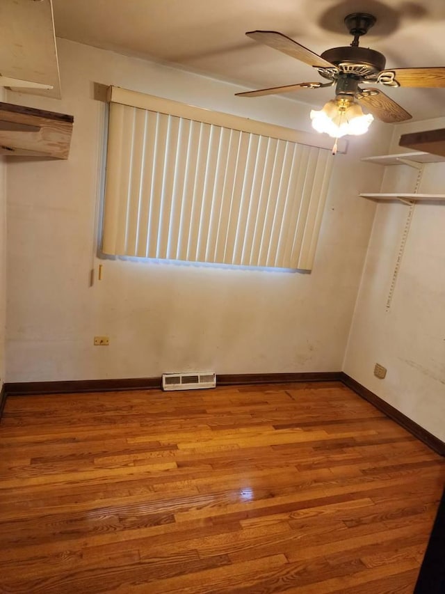 14842 Shepard Dr, Dolton, IL 60419 - empty room with wood finished floors, ceiling fan, and baseboards