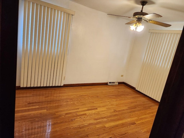 14842 Shepard Dr, Dolton, IL 60419 - spare room featuring light wood-style flooring, ceiling fan, and baseboards