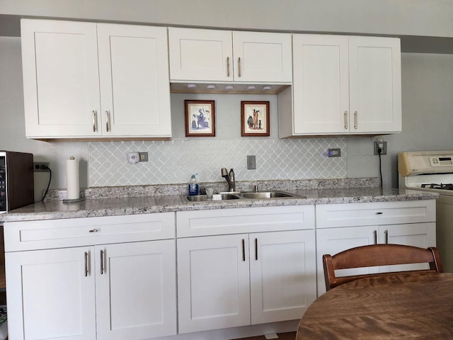 14842 Shepard Dr, Dolton, IL 60419 - kitchen with a sink, white stove, decorative backsplash, white cabinets, and light stone counters