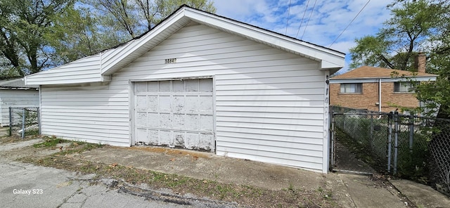 detached garage featuring fence