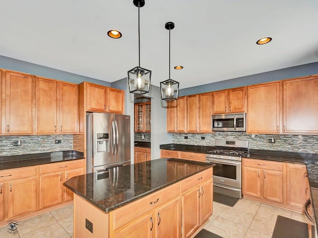 kitchen with a center island, appliances with stainless steel finishes, and tasteful backsplash