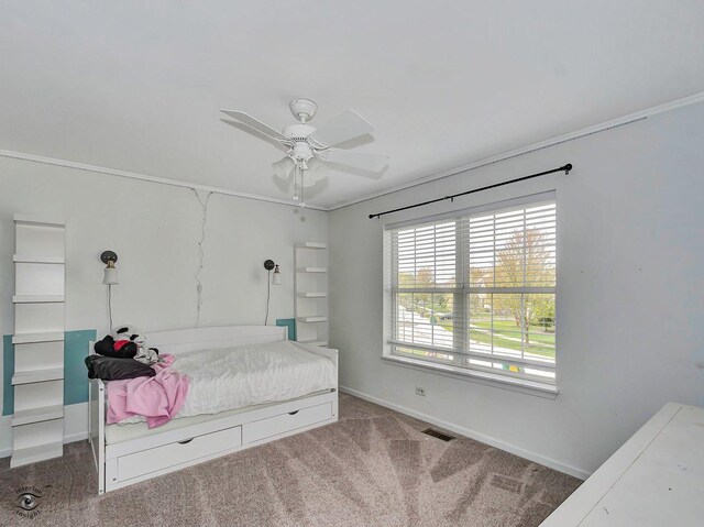 bedroom featuring crown molding, baseboards, visible vents, and carpet