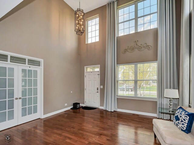 13905 Trillium Ln, Plainfield, IL 60544 - foyer entrance with wood-type flooring, a chandelier, a wealth of natural light, and a towering ceiling