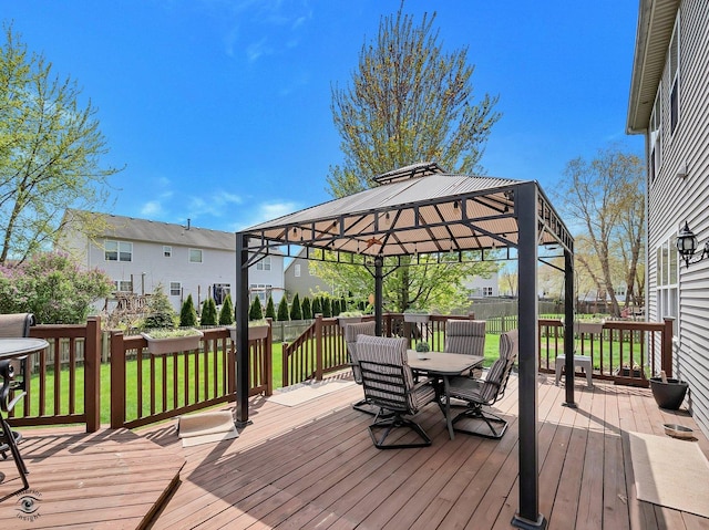 wooden deck featuring outdoor dining space, a gazebo, and a yard