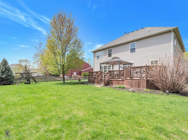 back of property featuring a gazebo, a lawn, fence, and a deck