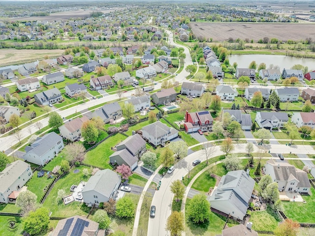 birds eye view of property featuring a water view and a residential view