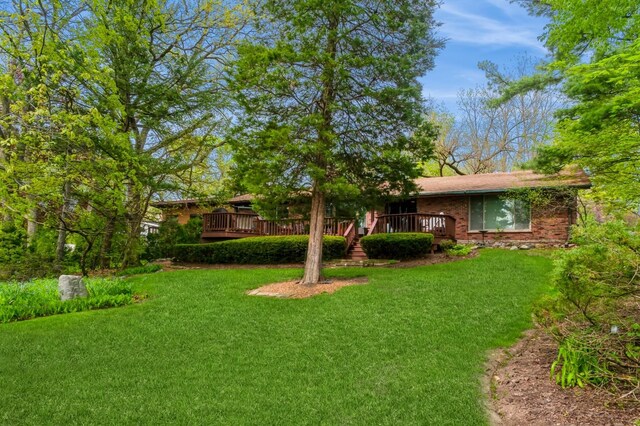 257 Banbury Rd, Mundelein, IL 60060 - view of front of house with a front lawn, brick siding, and a deck