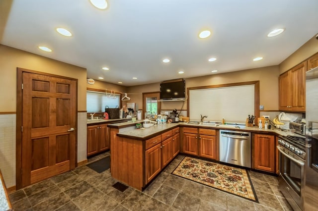257 Banbury Rd, Mundelein, IL 60060 - kitchen with a sink, a peninsula, brown cabinetry, stainless steel appliances, and recessed lighting