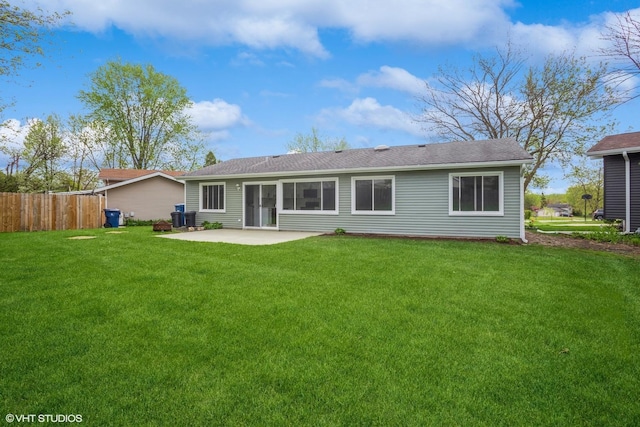 back of house with a lawn, a patio, and fence