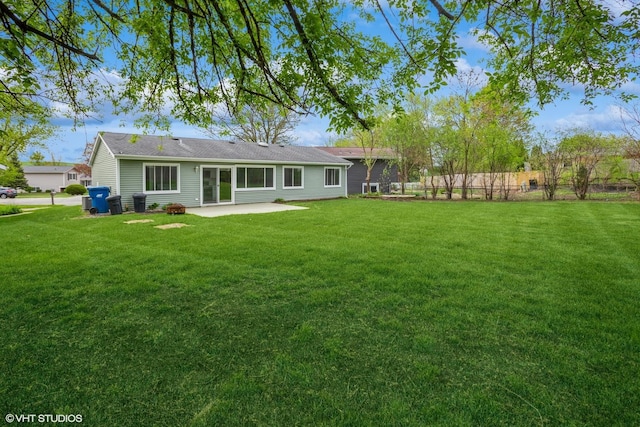 back of house featuring a yard and a patio area