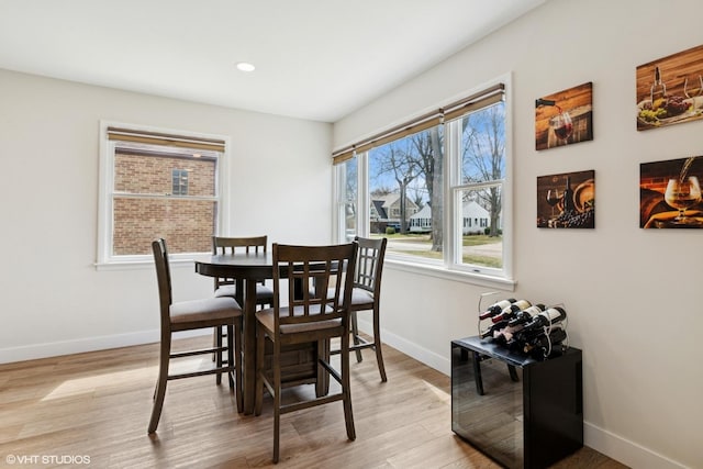 dining room with baseboards, recessed lighting, and light wood-style flooring
