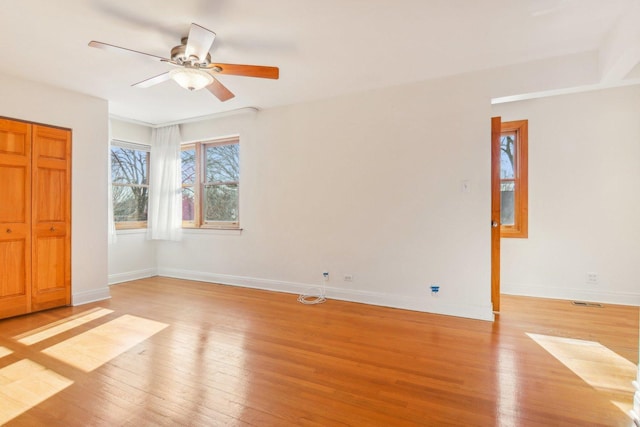 unfurnished bedroom featuring baseboards, a ceiling fan, and light wood finished floors