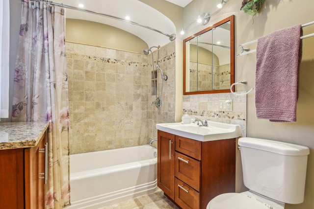 bathroom featuring vanity, shower / bath combination with curtain, and toilet