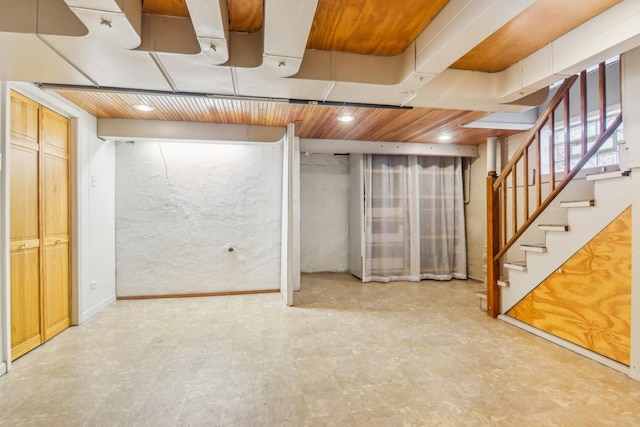 basement featuring light floors, recessed lighting, and stairs