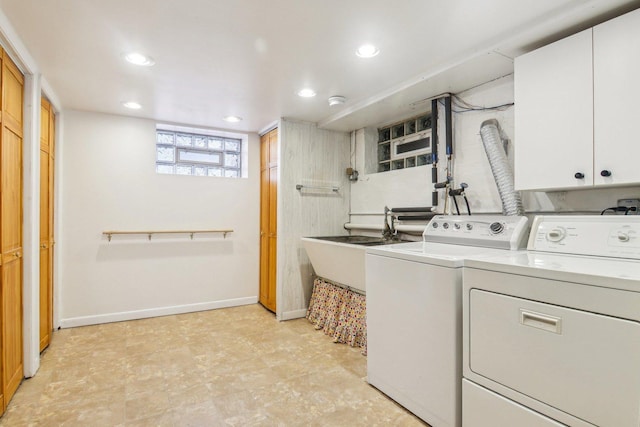 washroom featuring cabinet space, separate washer and dryer, recessed lighting, and a sink