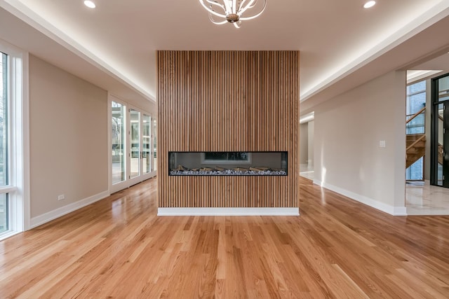 616 Glendale Rd, Glenview, IL 60025 - kitchen with baseboards, a fireplace, wood finished floors, and a notable chandelier
