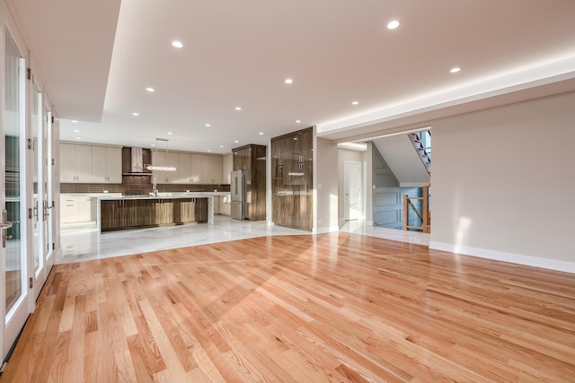 616 Glendale Rd, Glenview, IL 60025 - unfurnished living room with a sink, baseboards, light wood finished floors, and recessed lighting