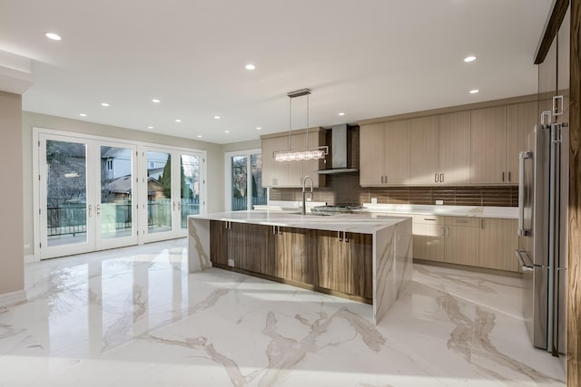 616 Glendale Rd, Glenview, IL 60025 - kitchen with marble finish floor, modern cabinets, wall chimney range hood, light countertops, and high end refrigerator