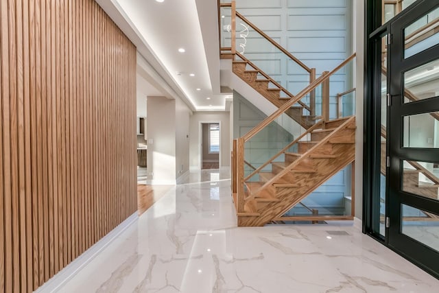 616 Glendale Rd, Glenview, IL 60025 - stairs featuring recessed lighting, marble finish floor, and a decorative wall