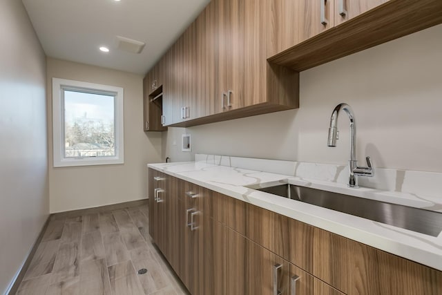 616 Glendale Rd, Glenview, IL 60025 - kitchen with a sink, baseboards, modern cabinets, and light stone countertops