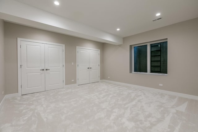 616 Glendale Rd, Glenview, IL 60025 - unfurnished bedroom with visible vents, baseboards, multiple closets, light carpet, and recessed lighting