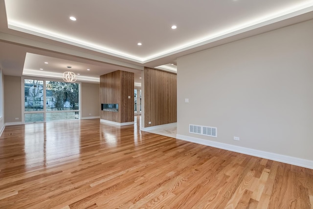 616 Glendale Rd, Glenview, IL 60025 - unfurnished living room with a raised ceiling, recessed lighting, and visible vents