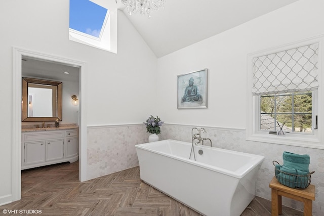 30 Rue Foret, Lake Forest, IL 60045 - bathroom with a wainscoted wall, lofted ceiling, a skylight, a soaking tub, and vanity