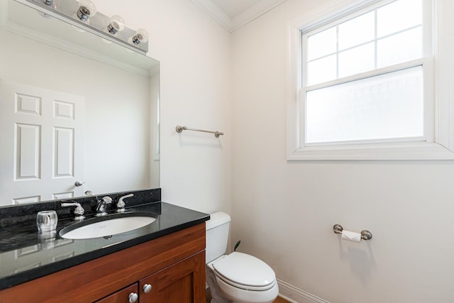 bathroom with crown molding, vanity, and toilet