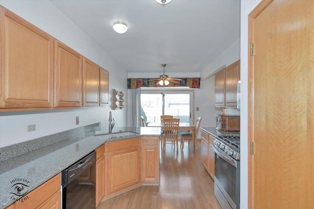 kitchen featuring a ceiling fan, gas range, light wood-type flooring, a sink, and dishwasher
