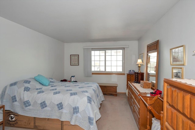 bedroom with baseboards and light colored carpet