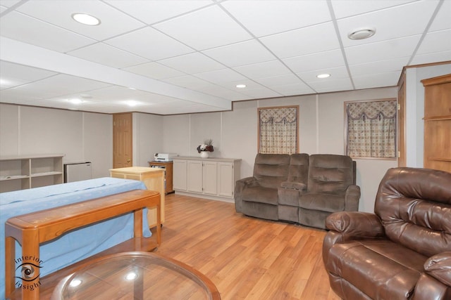 living room featuring recessed lighting, a drop ceiling, and light wood-style floors