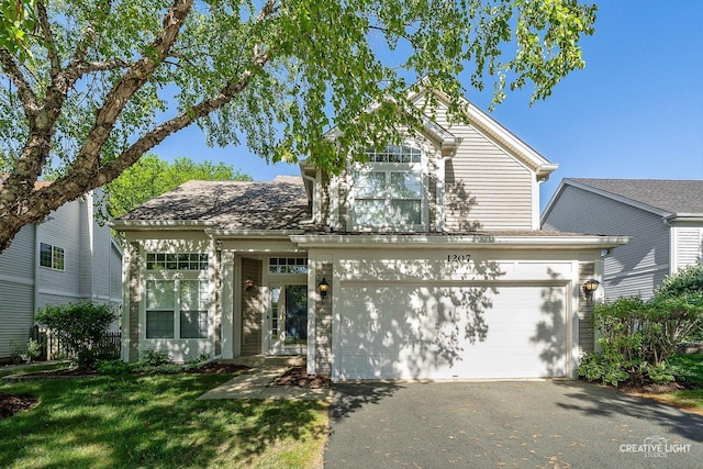 1207 Pennsbury Ln, Aurora, IL 60502 - traditional home featuring driveway, an attached garage, and a front lawn