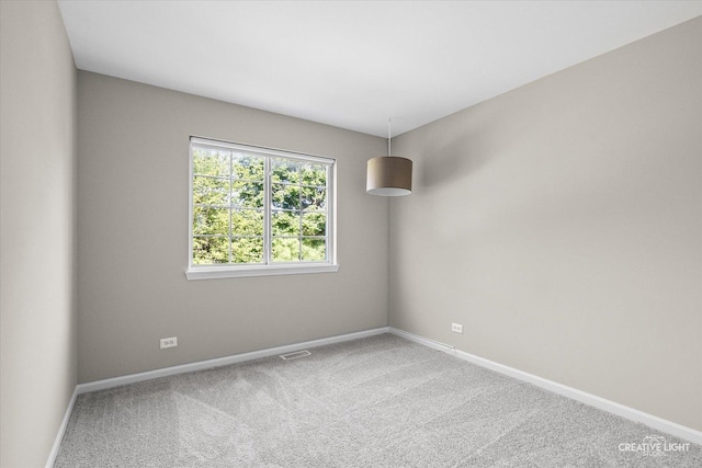 1207 Pennsbury Ln, Aurora, IL 60502 - spare room featuring baseboards and carpet