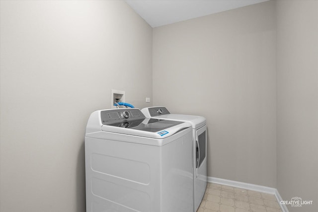 1207 Pennsbury Ln, Aurora, IL 60502 - laundry room featuring washing machine and clothes dryer, baseboards, and light floors